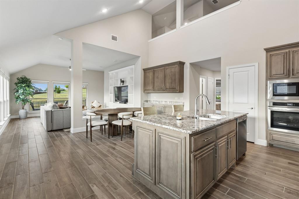 2137 Charming Frg Road Forney, TX 75126 - Photo 4 of 35 a kitchen with a stove and cabinets