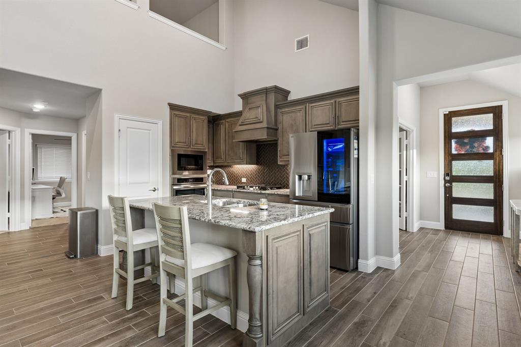 2137 Charming Frg Road Forney, TX 75126 - Photo 8 of 35 a kitchen that has a table and chairs in it