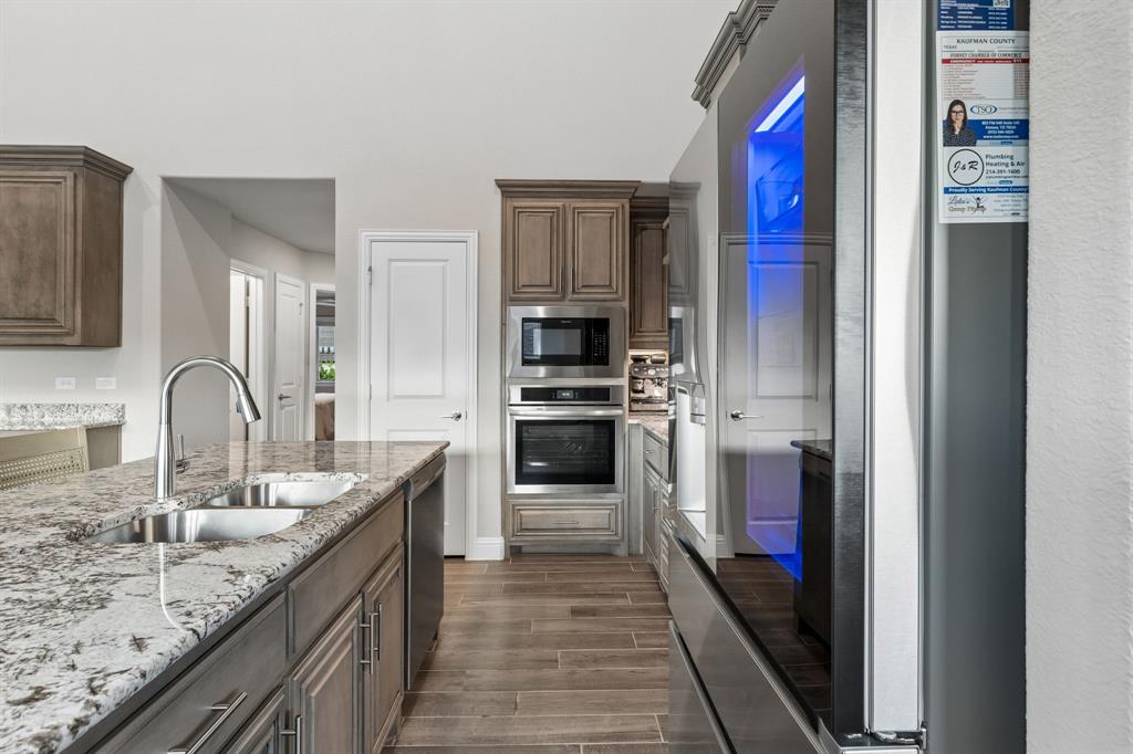 2137 Charming Frg Road Forney, TX 75126 - Photo 9 of 35 a kitchen with stainless steel appliances granite countertop a refrigerator and a sink