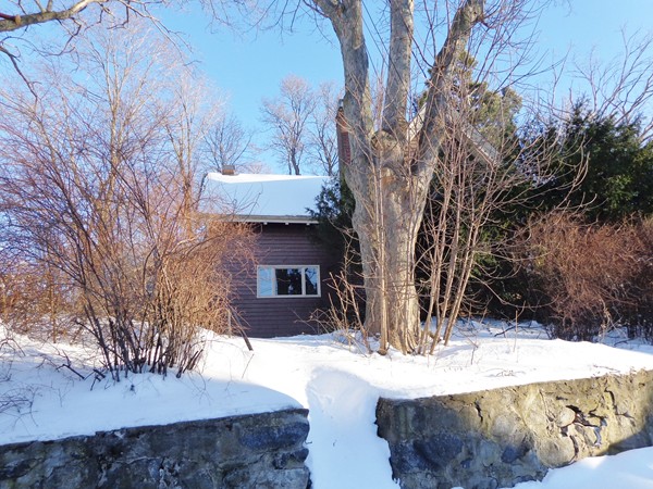 a view of a house with a yard covered with snow