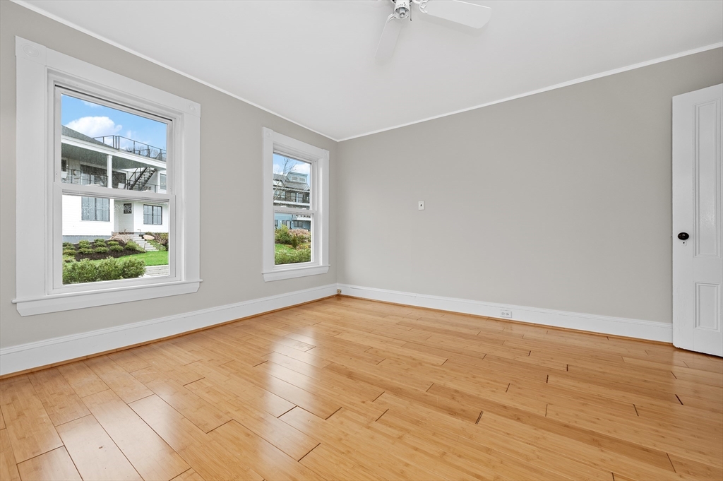 18 Bennett Street, Unit 2 Manchester, MA 01944 - Photo 14 of 21 a view of an empty room with wooden floor and a window