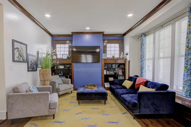 a living room with furniture fireplace and a flat screen tv