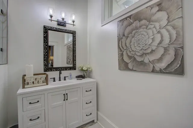 a bathroom with a double vanity sink and a mirror