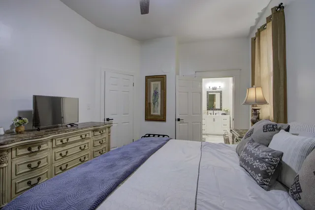 a bedroom with a bed and flat screen tv