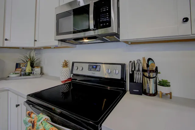 a kitchen with stainless steel appliances granite countertop a stove and a microwave