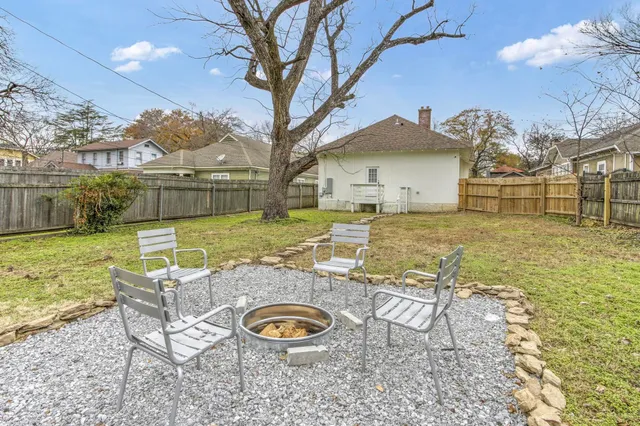a view of a house with backyard and sitting area