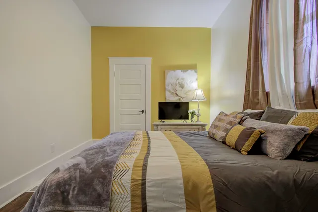 a bedroom with a bed and a fireplace