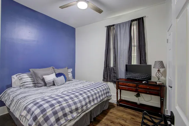 a bedroom with a bed and a flat screen tv