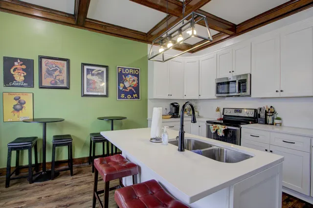 a kitchen with a table chairs and a refrigerator