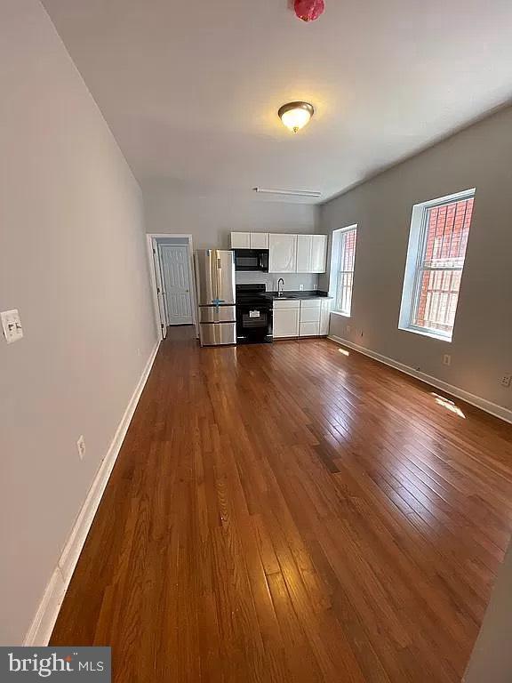 1505 North Capitol Street Northeast, Unit 3 Washington, DC 20002 - Photo 2 of 5 a living room with furniture and a wooden floor