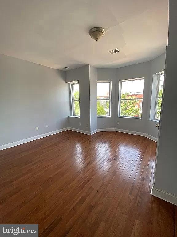 1505 North Capitol Street Northeast, Unit 3 Washington, DC 20002 - Photo 5 of 5 a view of an empty room with wooden floor and windows