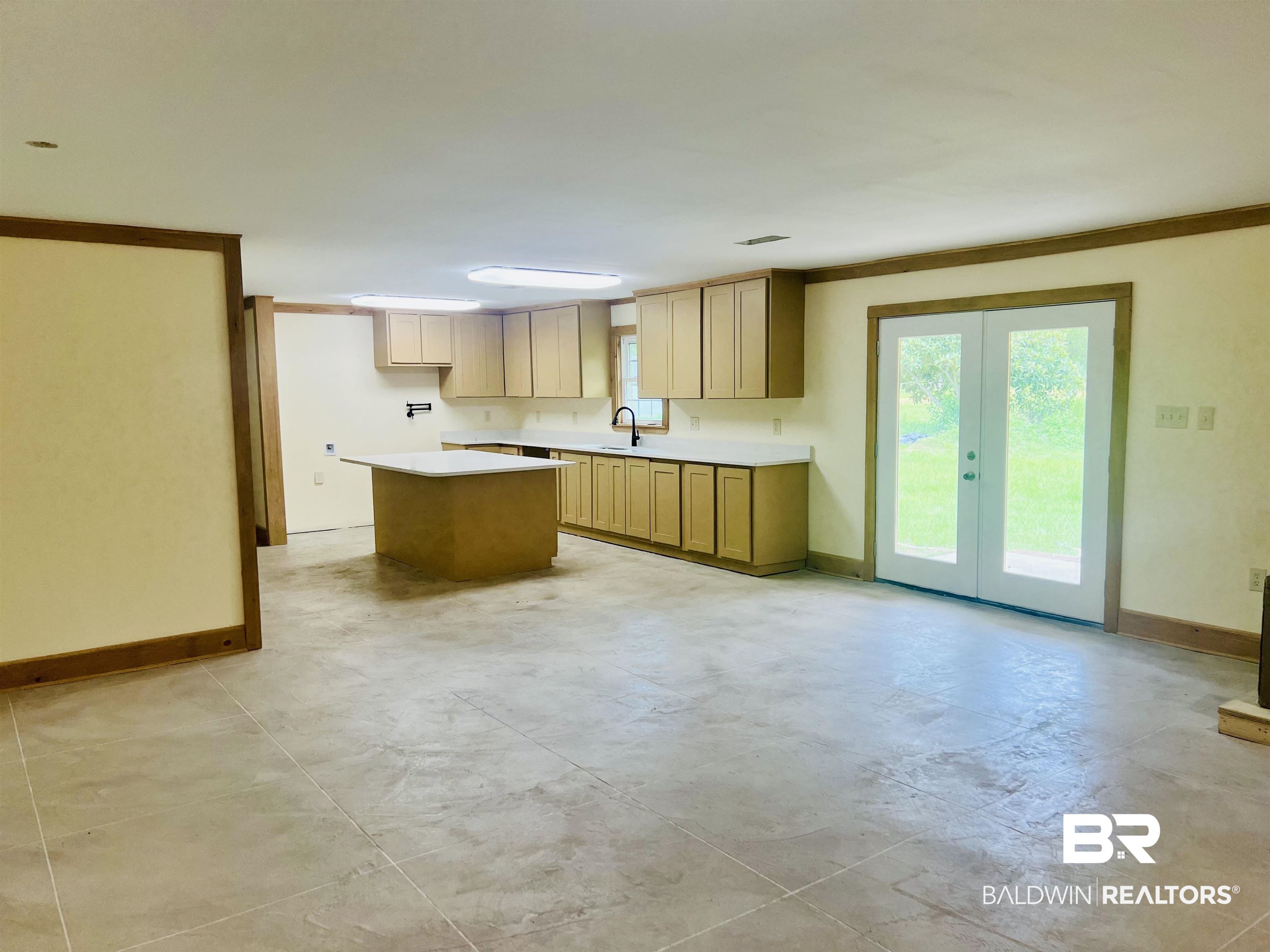 29685 Gardner Road Elberta, AL 36530 - Photo 3 of 16 Spacious open-concept living area featuring light-toned cabinetry, light countertops, and a kitchen island