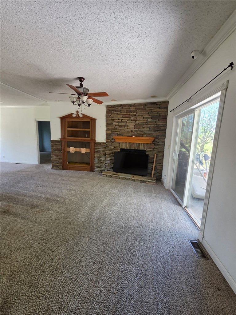 1400 Massey Road Pendleton, SC 29670 - Photo 7 of 25 This inviting living space features a cozy fireplace and convenient sliding glass doors leading outdoors.