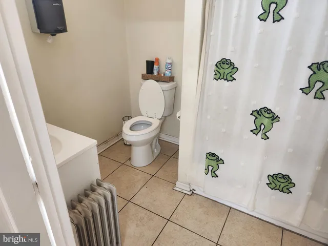 a white toilet sitting next to a white tub