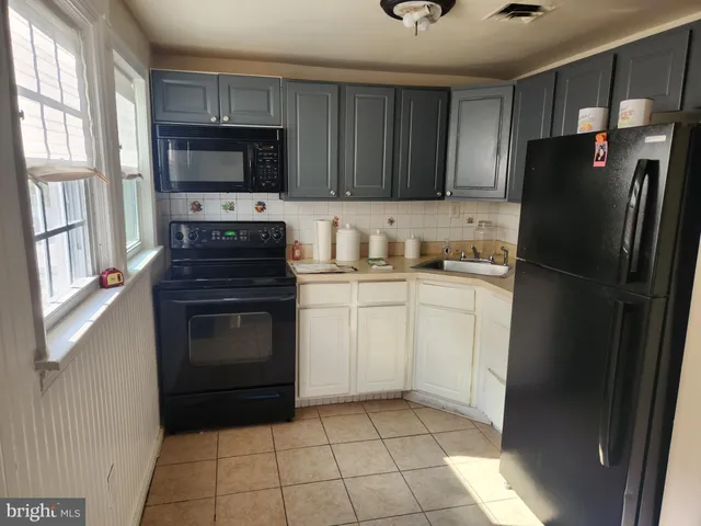 a kitchen with a sink stove and refrigerator