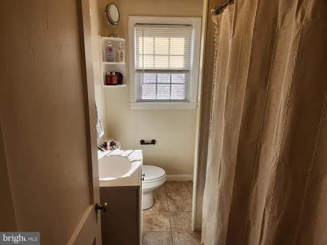 a bathroom with a sink a toilet and tub