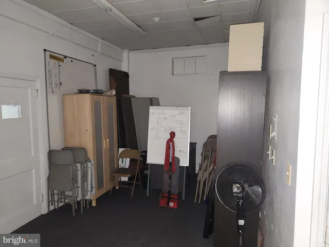 a view of a storage and utility room with refrigerator