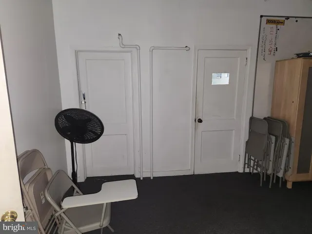 a view of a hallway with seating area