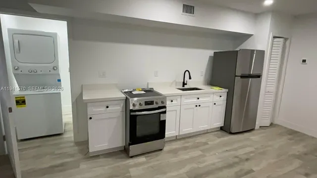 a kitchen with a stove sink and refrigerator