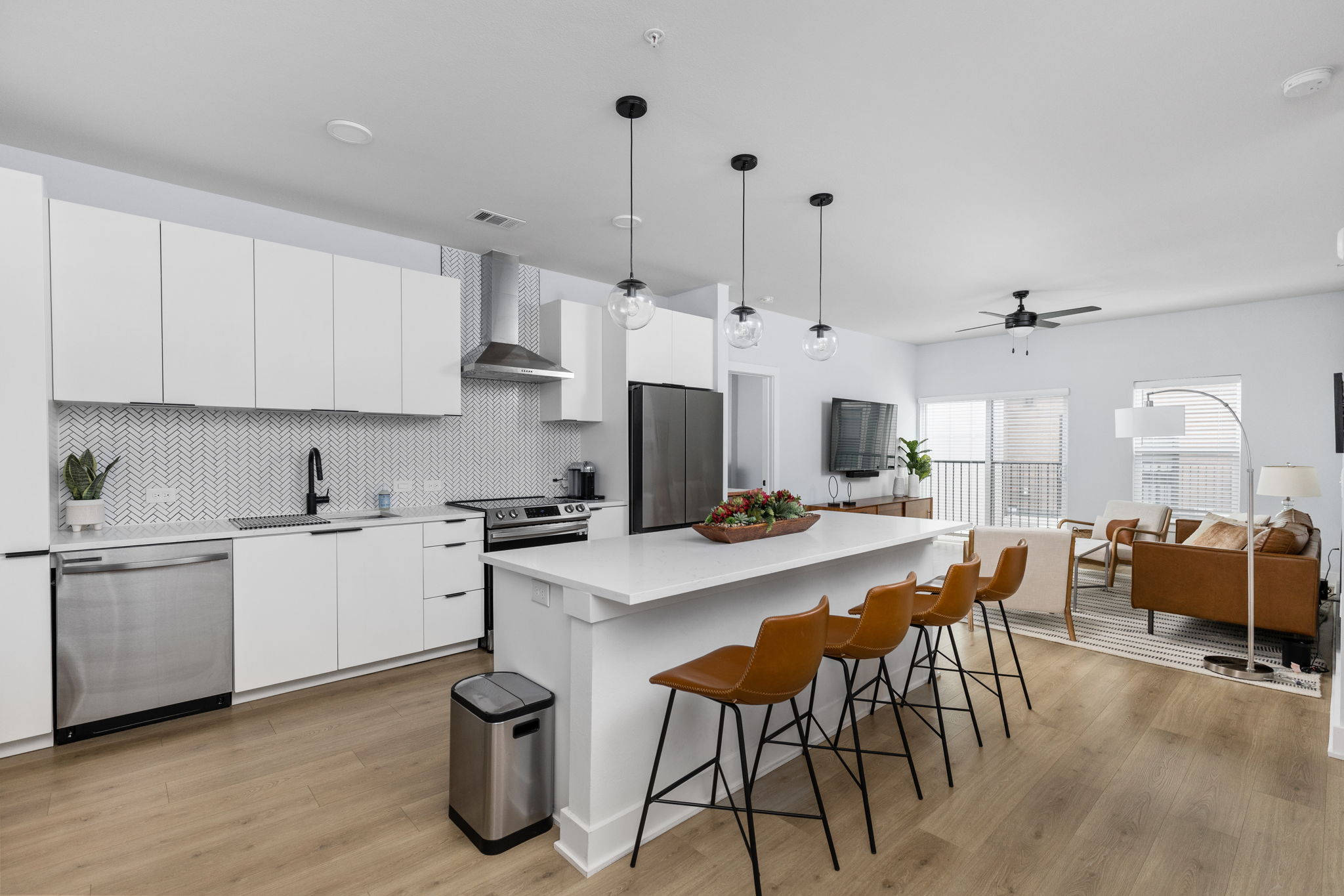 2500 Longview Street, Unit 507 Austin, TX 78705 - Photo 10 of 37 Kitchen featuring a center island, stainless steel appliances, white cabinetry, and backsplash