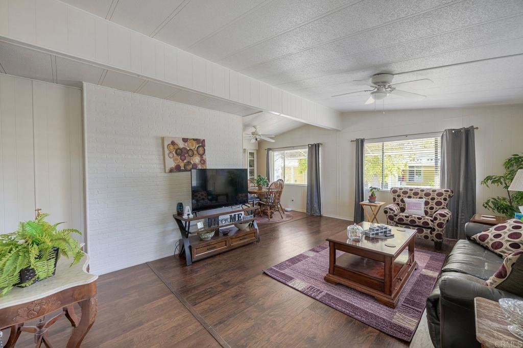 18218 Paradise Mountain Road Valley Center, CA 92082 - Photo 12 of 34 a living room with furniture and a flat screen tv