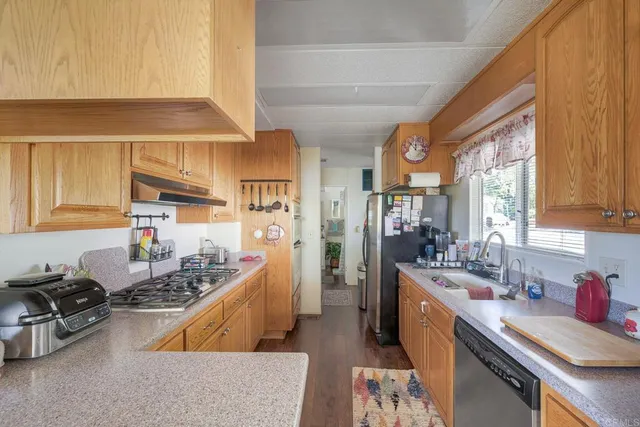 a kitchen with sink a stove and cabinets