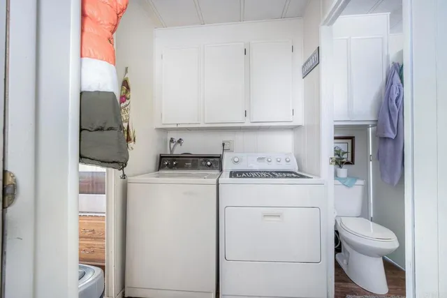 a view of washer and dryer with bathroom