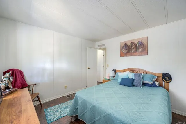 a bedroom with a bed and a couch