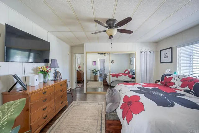 a bed room with a bed a couch and dresser