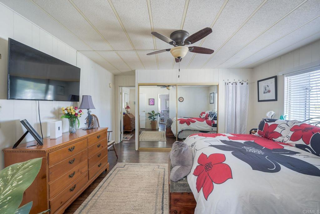 18218 Paradise Mountain Road Valley Center, CA 92082 - Photo 25 of 34 a bed room with a bed a couch and dresser