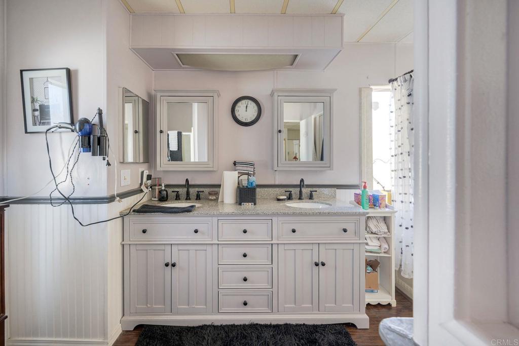 18218 Paradise Mountain Road Valley Center, CA 92082 - Photo 26 of 34 a bathroom with a double vanity sink and a mirror