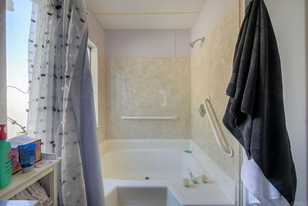 18218 Paradise Mountain Road Valley Center, CA 92082 - Photo 27 of 34 a bathroom with a bathtub and a shower