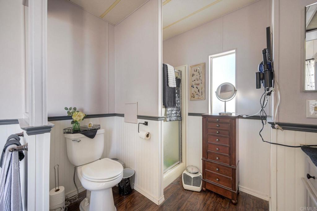18218 Paradise Mountain Road Valley Center, CA 92082 - Photo 28 of 34 a bathroom with a toilet sink and mirror