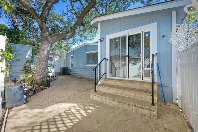 a view of house with backyard and sitting area