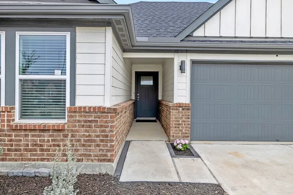 a view of kitchen with kitchen island and stainless steel appliances