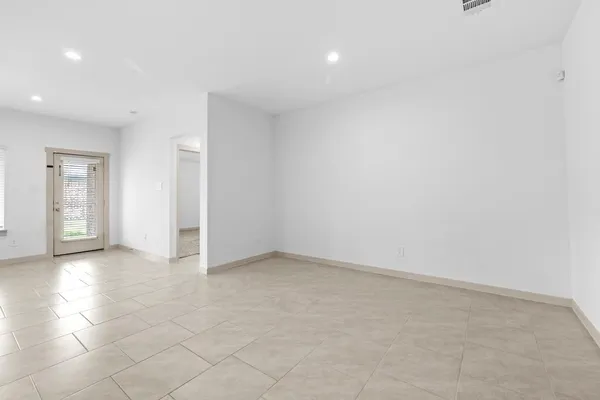 an empty room with windows and entrance