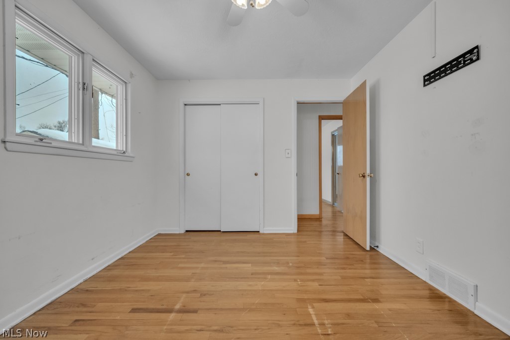 6846 Revere Road Cleveland, OH 44130 - Photo 22 of 30 Unfurnished bedroom with light wood-type flooring, ceiling fan, and a closet