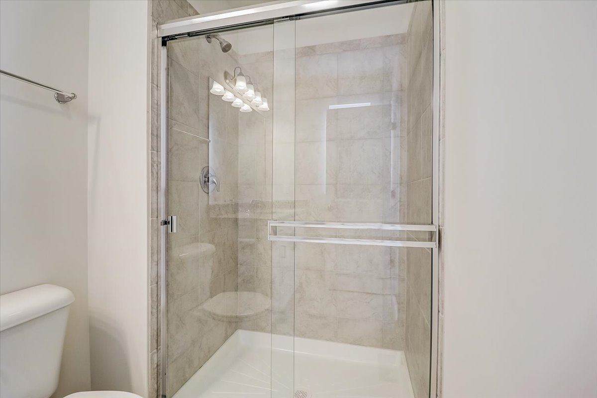 715 Station Boulevard Elburn, IL 60119 - Photo 18 of 33 a bathroom with a glass shower door