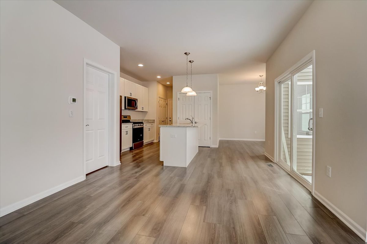 715 Station Boulevard Elburn, IL 60119 - Photo 5 of 33 a view of a kitchen with wooden floor and a window