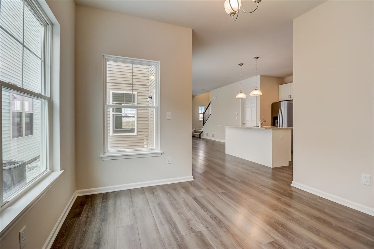 715 Station Boulevard Elburn, IL 60119 - Photo 9 of 33 a view of empty room with wooden floor and fan