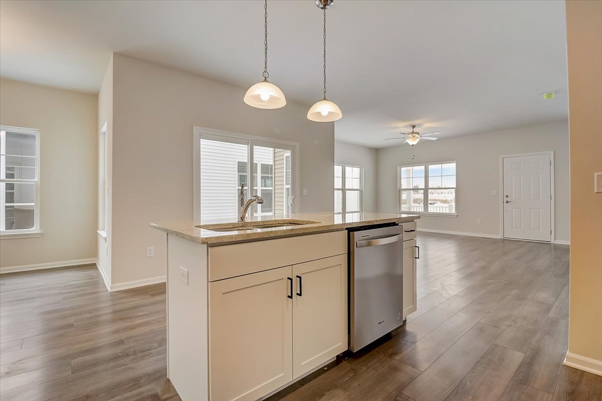 715 Station Boulevard Elburn, IL 60119 - Photo 10 of 33 a kitchen with a refrigerator a sink and dishwasher with wooden floor