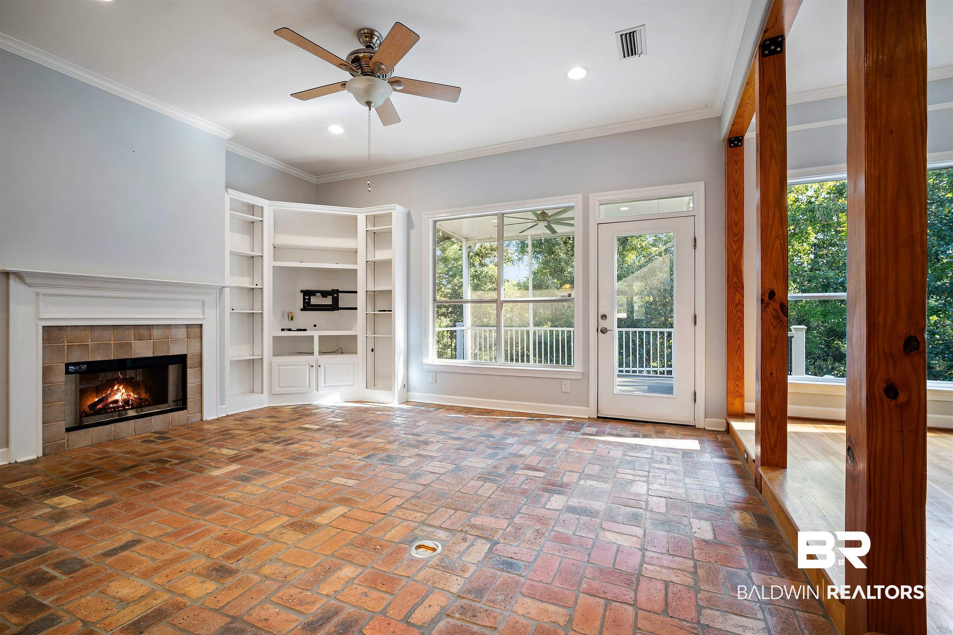 204 General Canby Loop Daphne, AL 36527 - Photo 7 of 36 Unfurnished living room with ornamental molding, ceiling fan, and a tile fireplace