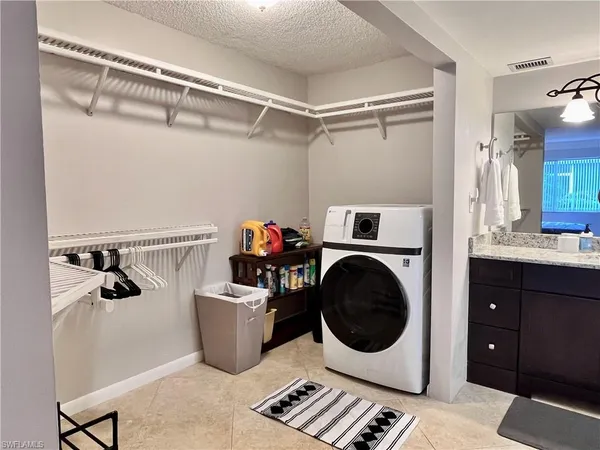 a utility room with sink dryer and washer