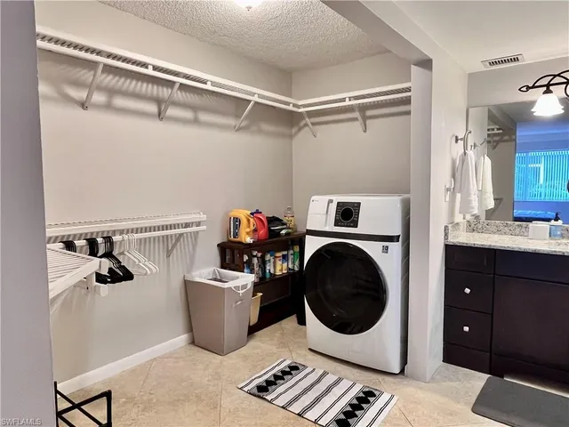 a utility room with sink dryer and washer