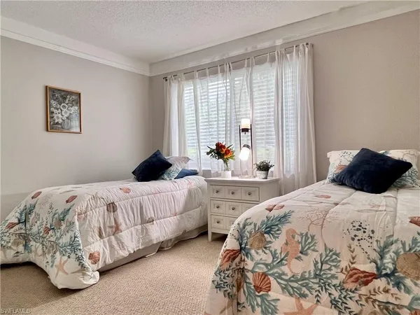 a bedroom with bed and a window