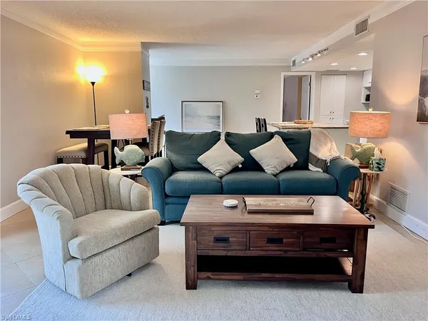 a living room with furniture and a lamp