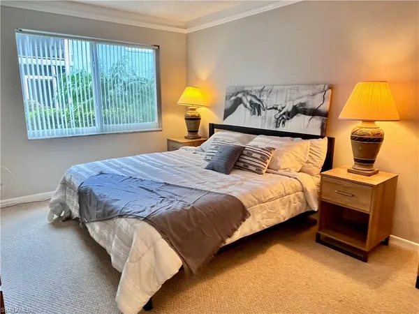 a bedroom with a bed and lamp