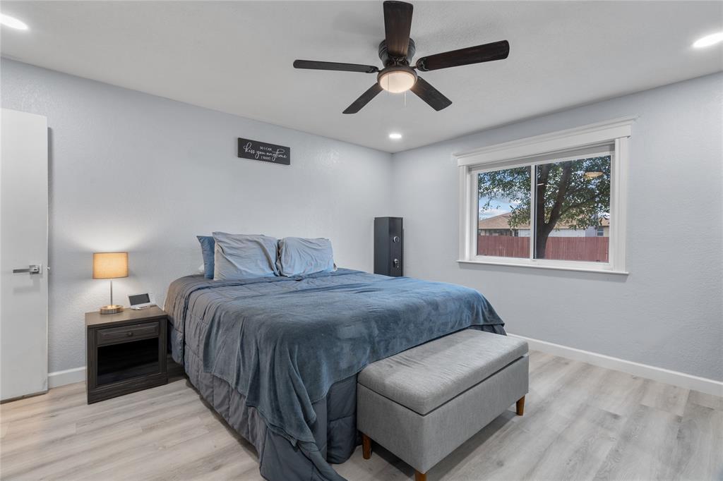 7629 Cedarhill Road Watauga, TX 76148 - Photo 11 of 26 Wood-finish flooring, recessed lighting, ceiling fan with integrated light, and a window with white trim