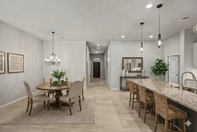a bedroom with a bed lamp and a potted plant