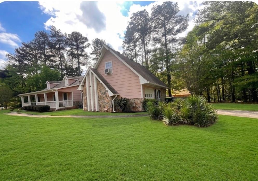 a front view of house with yard and green space
